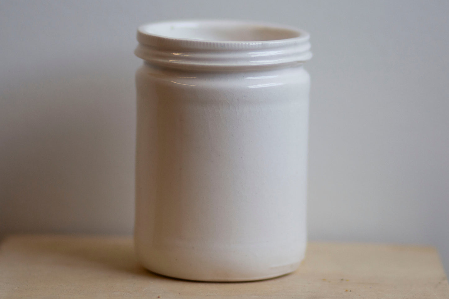glossy white jar shaped cup