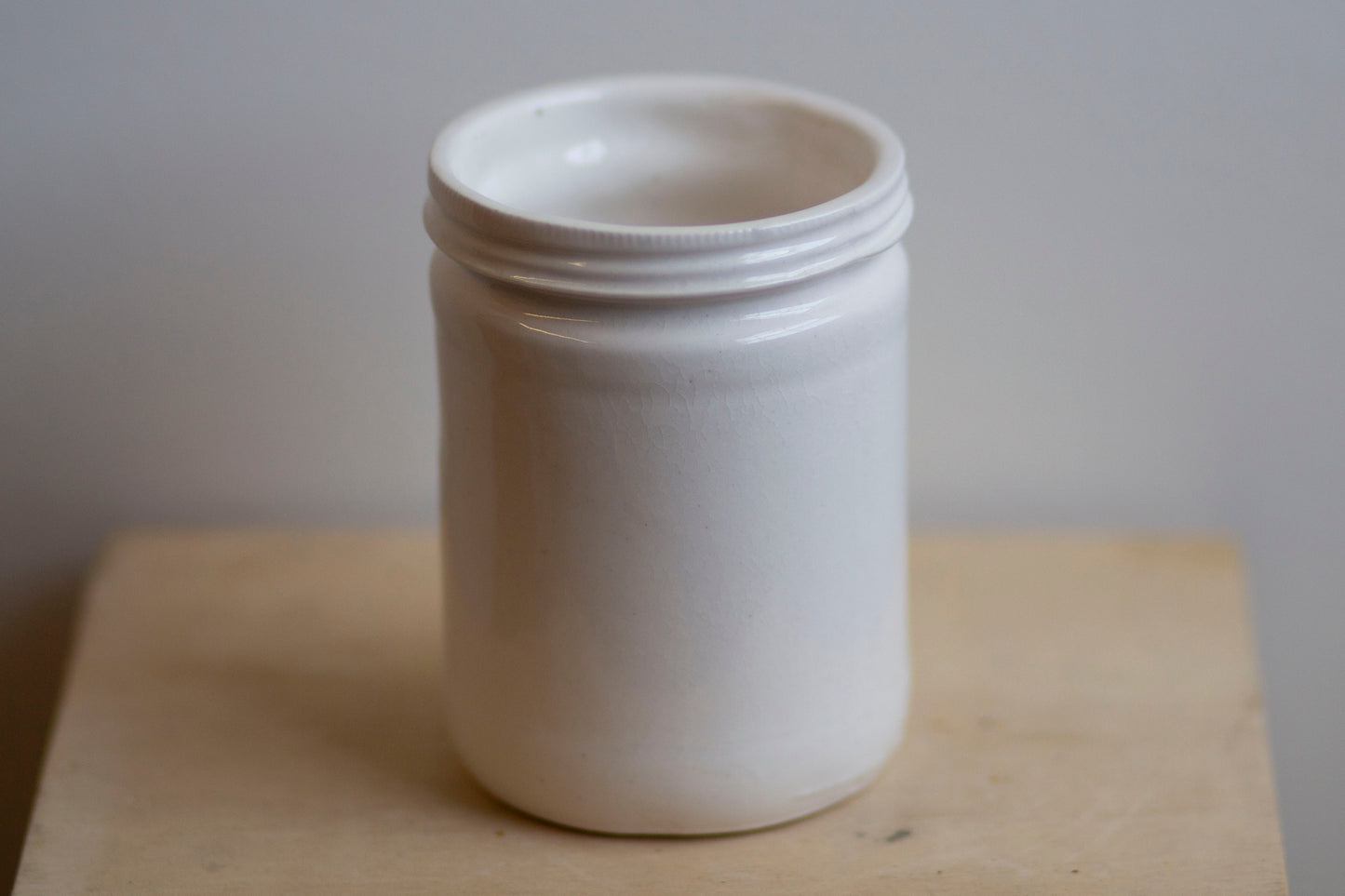 glossy white jar shaped cup
