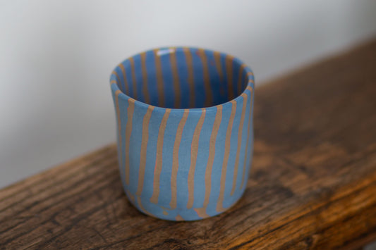 blue and orange striped cup