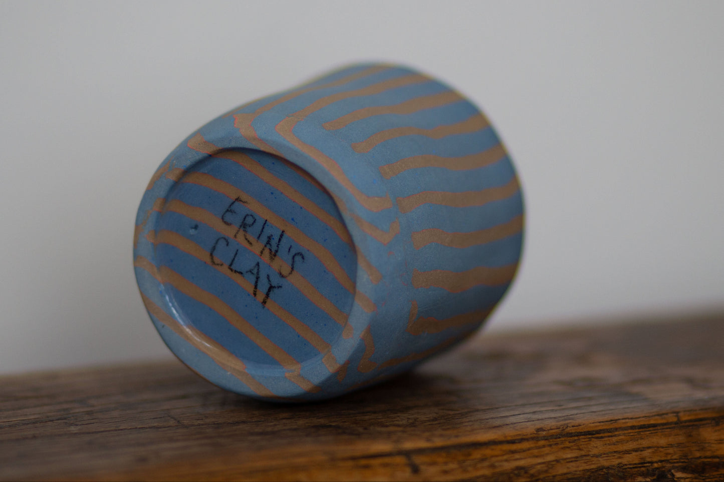 blue and orange striped cup