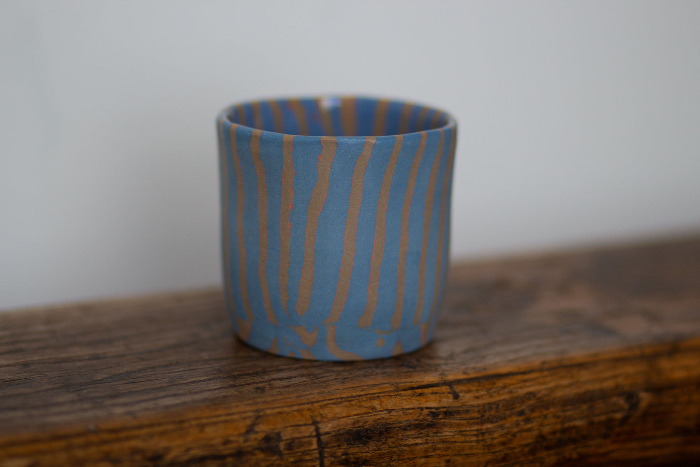 blue and orange striped cup