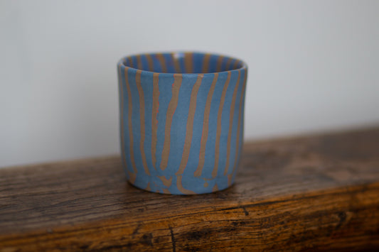 blue and orange striped cup