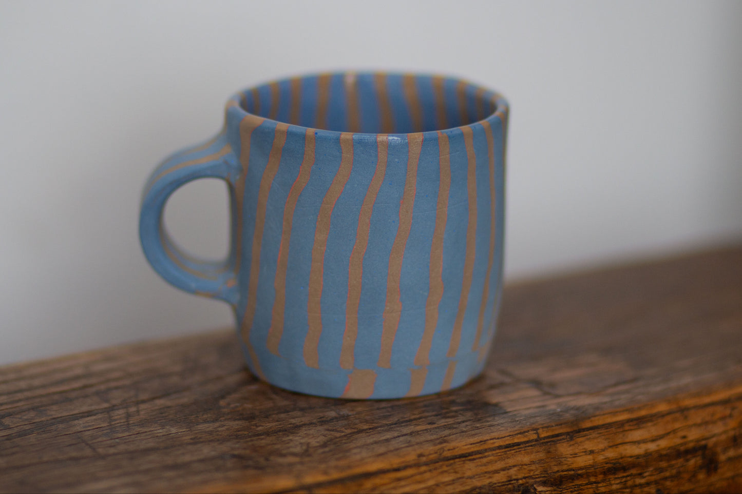 blue and orange striped mug