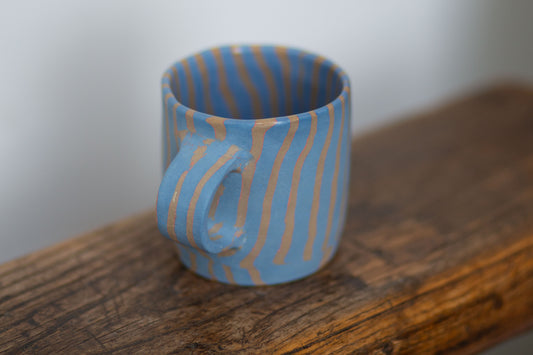 blue and orange striped mug