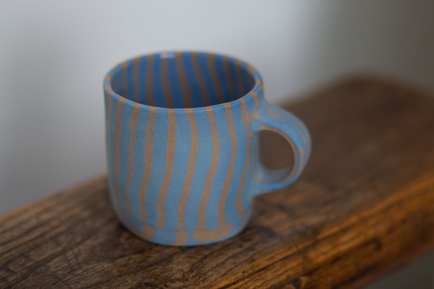 blue and orange striped mug